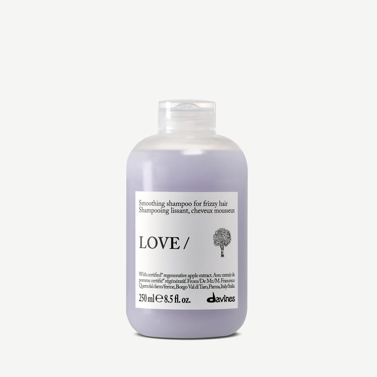 A bottle of Davines LOVE smoothing shampoo for curly and frizzy hair, featuring a lavender-colored liquid in a frosted bottle with a white label.
