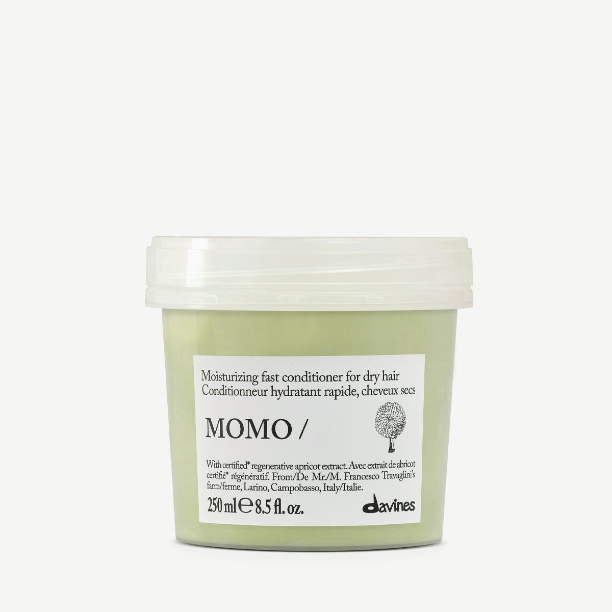 A tub of Davines Momo Moisturizing Fast Conditioner for dry hair, featuring a pale sage green container and a white lid, set against a plain light gray background.