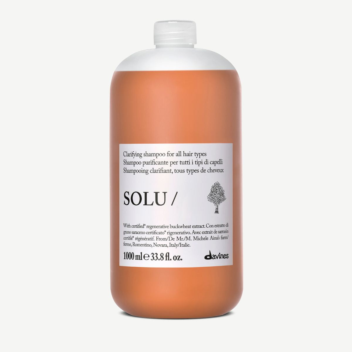 A 1000 ml bottle of Solu Clarity Shampoo for all hair types, featuring a translucent white cap and a white label with black text, set against a solid off-white background.