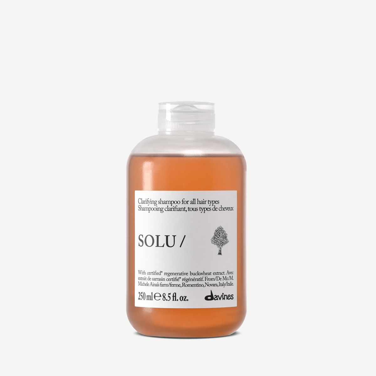 Davines Solu Shampoo bottle with a white label on a white background