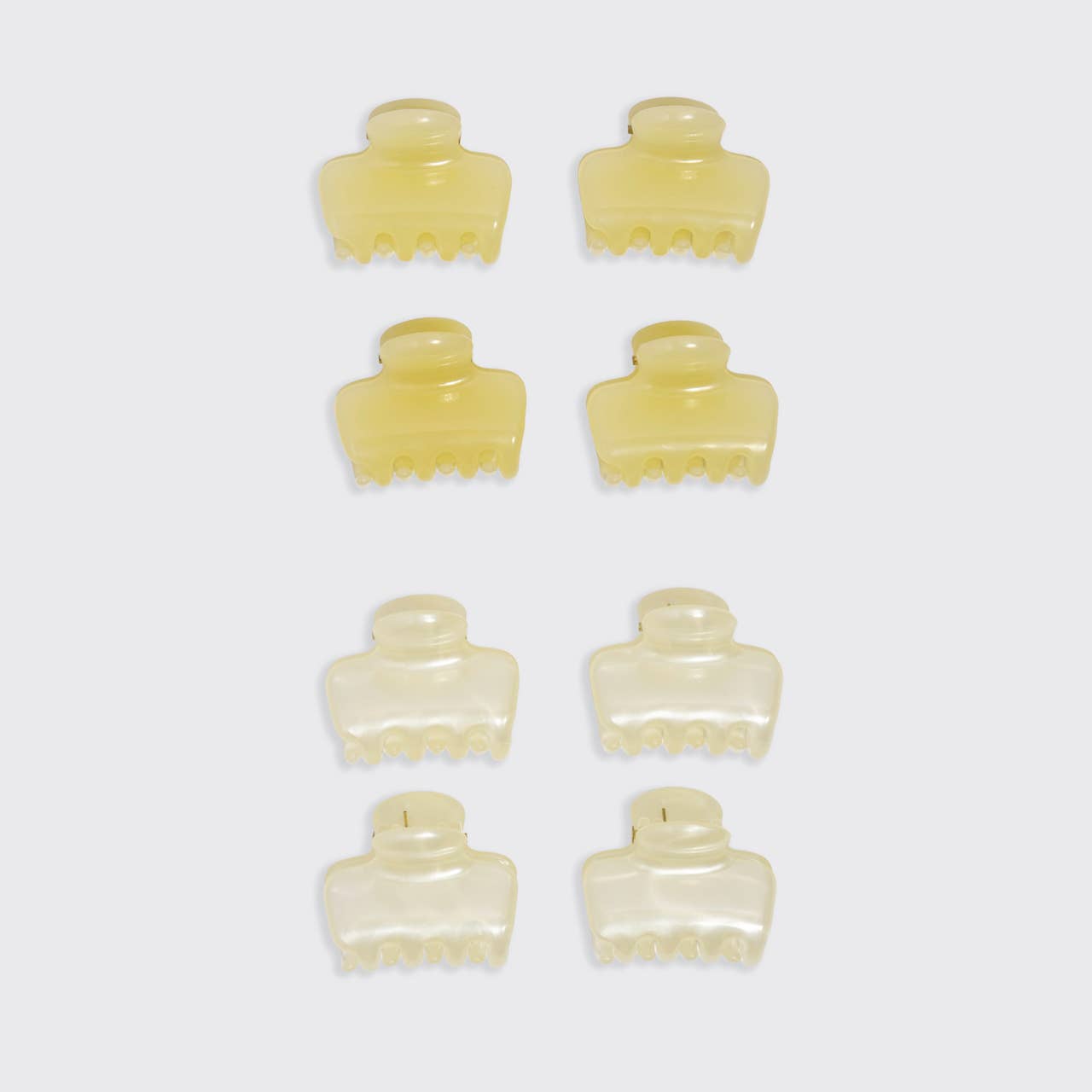 Set of eight KITSCH claw clips cream-colored hair clips on a white background