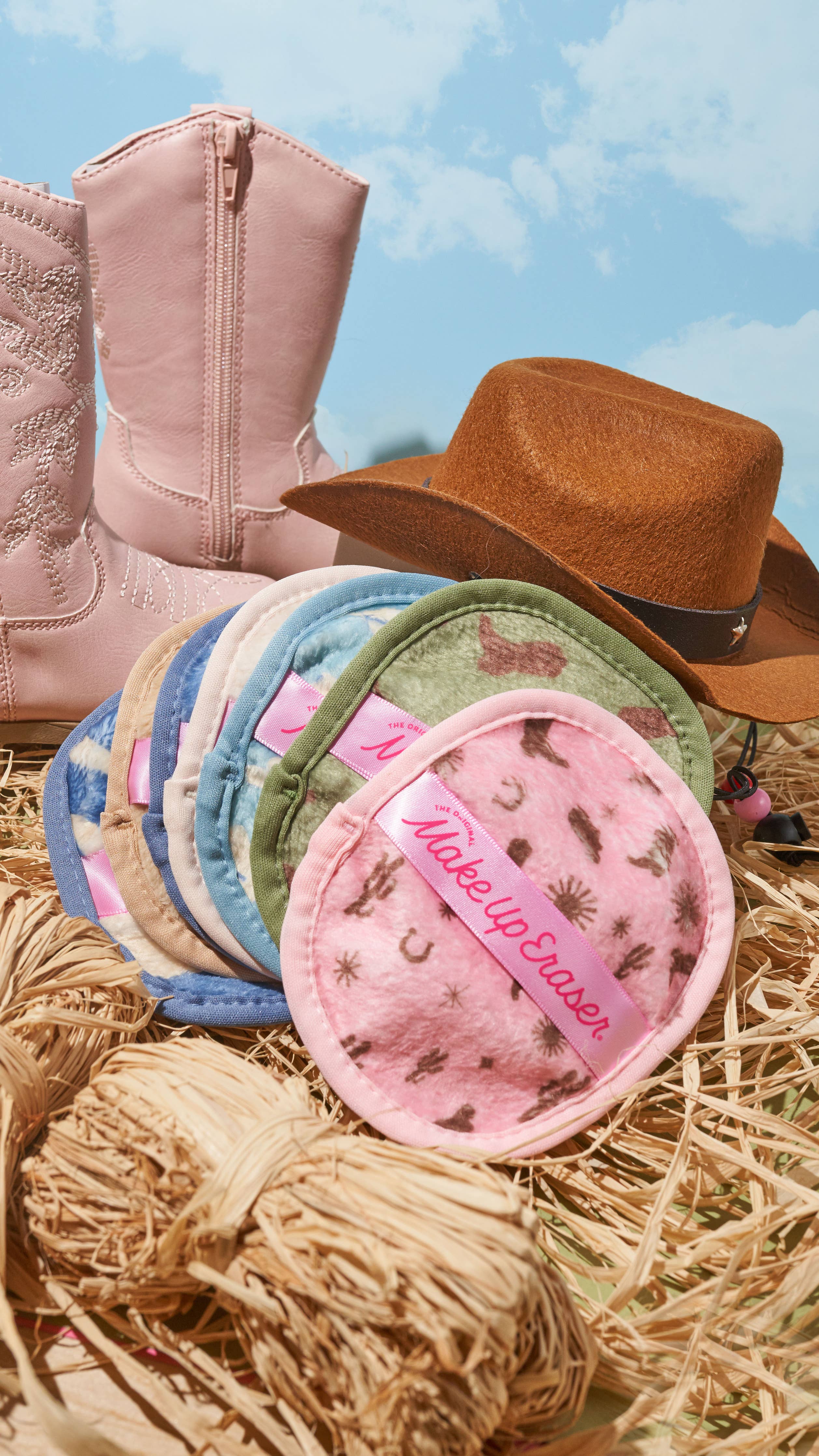 Set of The Makeup Eraser makeup removal pads with a pink boot and brown cowboy hat 
