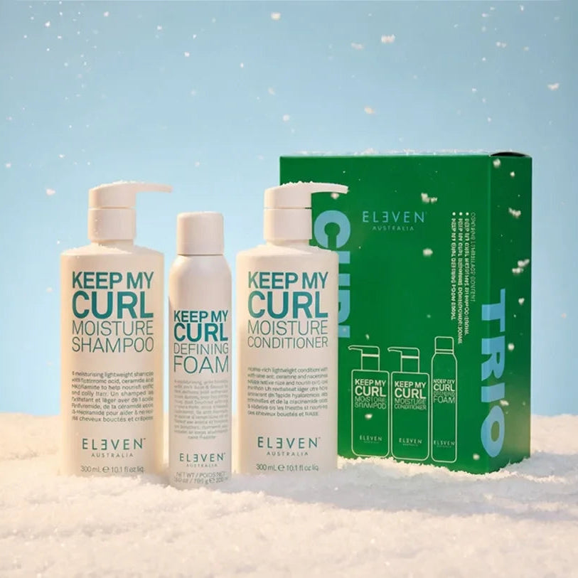 Elven Keep My Curl haircare products with a green box on a snowy background
