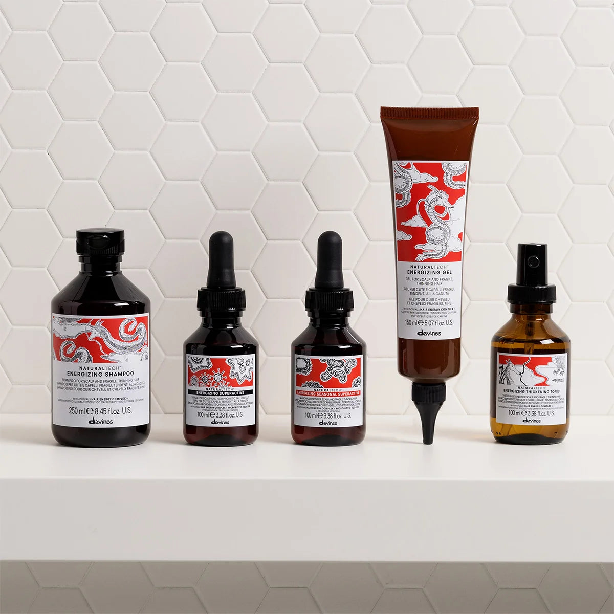 Set of Davines Naturaltech Energizing hair care products on a white tiled backgroun