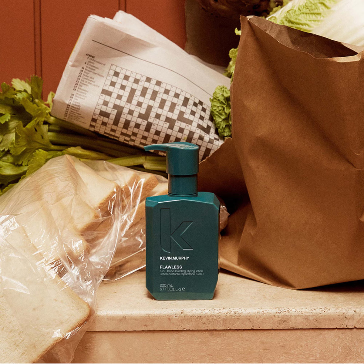A teal pump bottle of Kevin Murphy Flawless 6 in 1 bond repair lotion