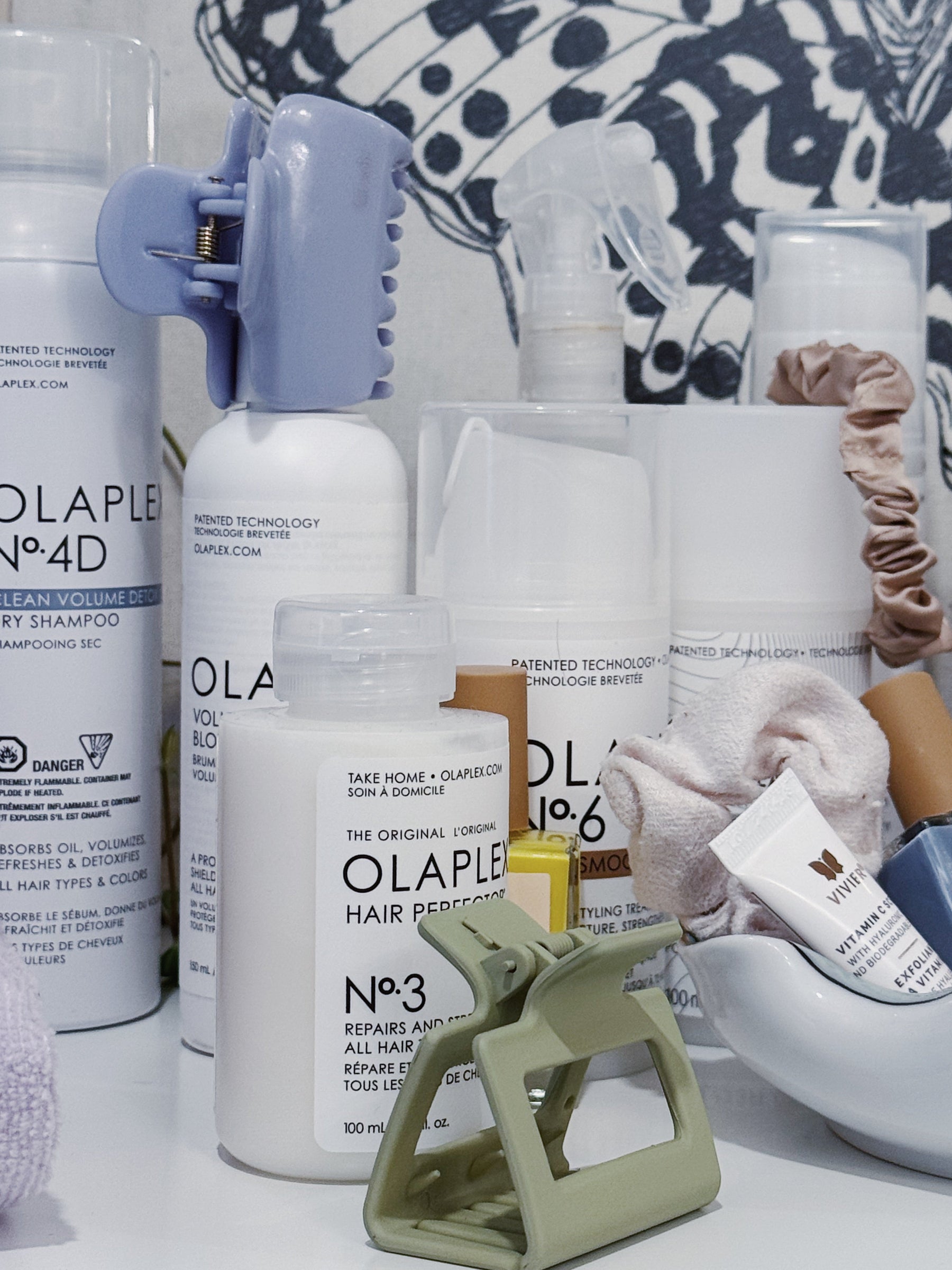 Collection of Olaplex hair care products with hair clips and vivier skincare